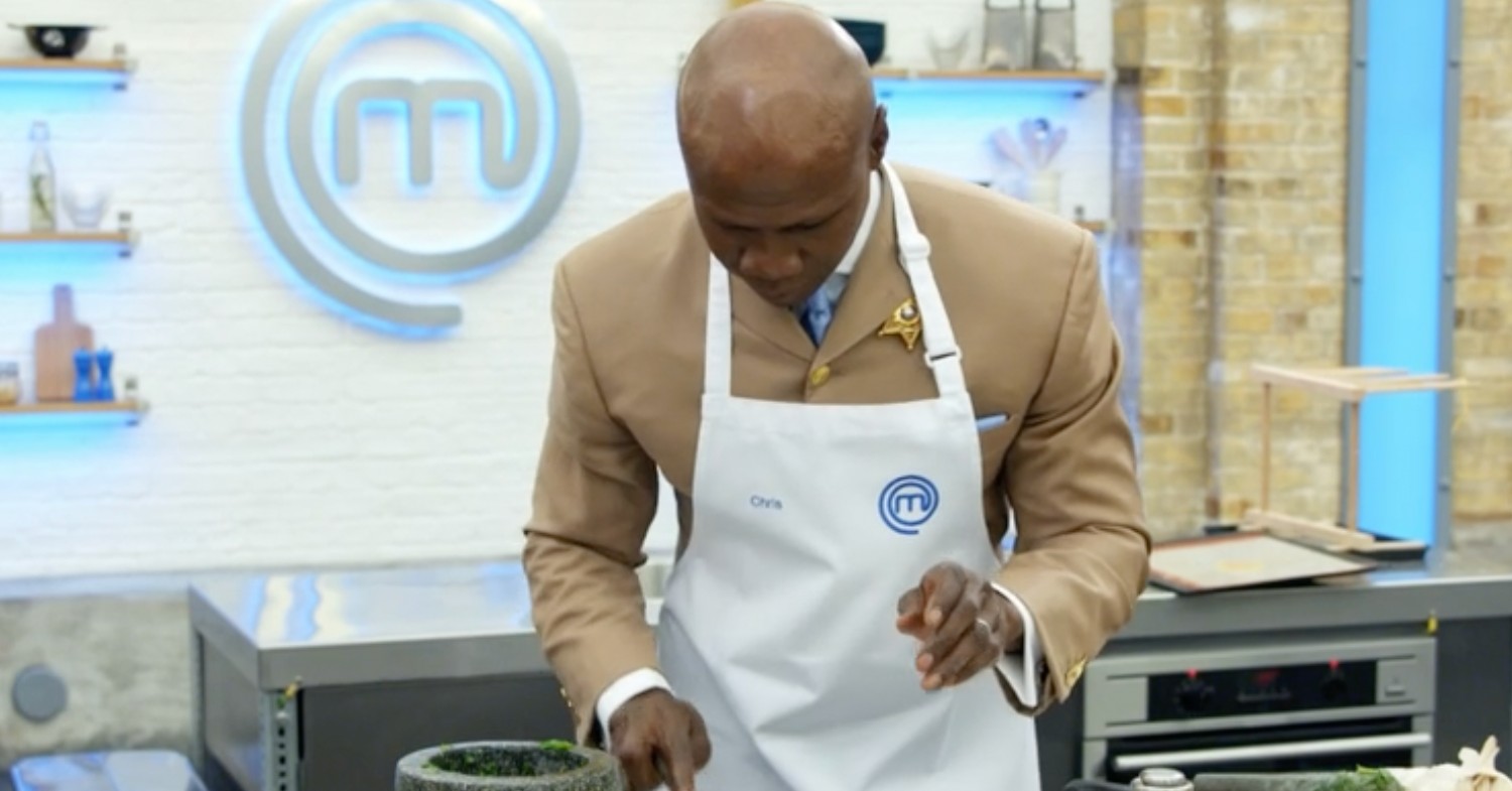 Chris Eubank cooking in a beige suit and white apron on Celebrity Masterchef 2022