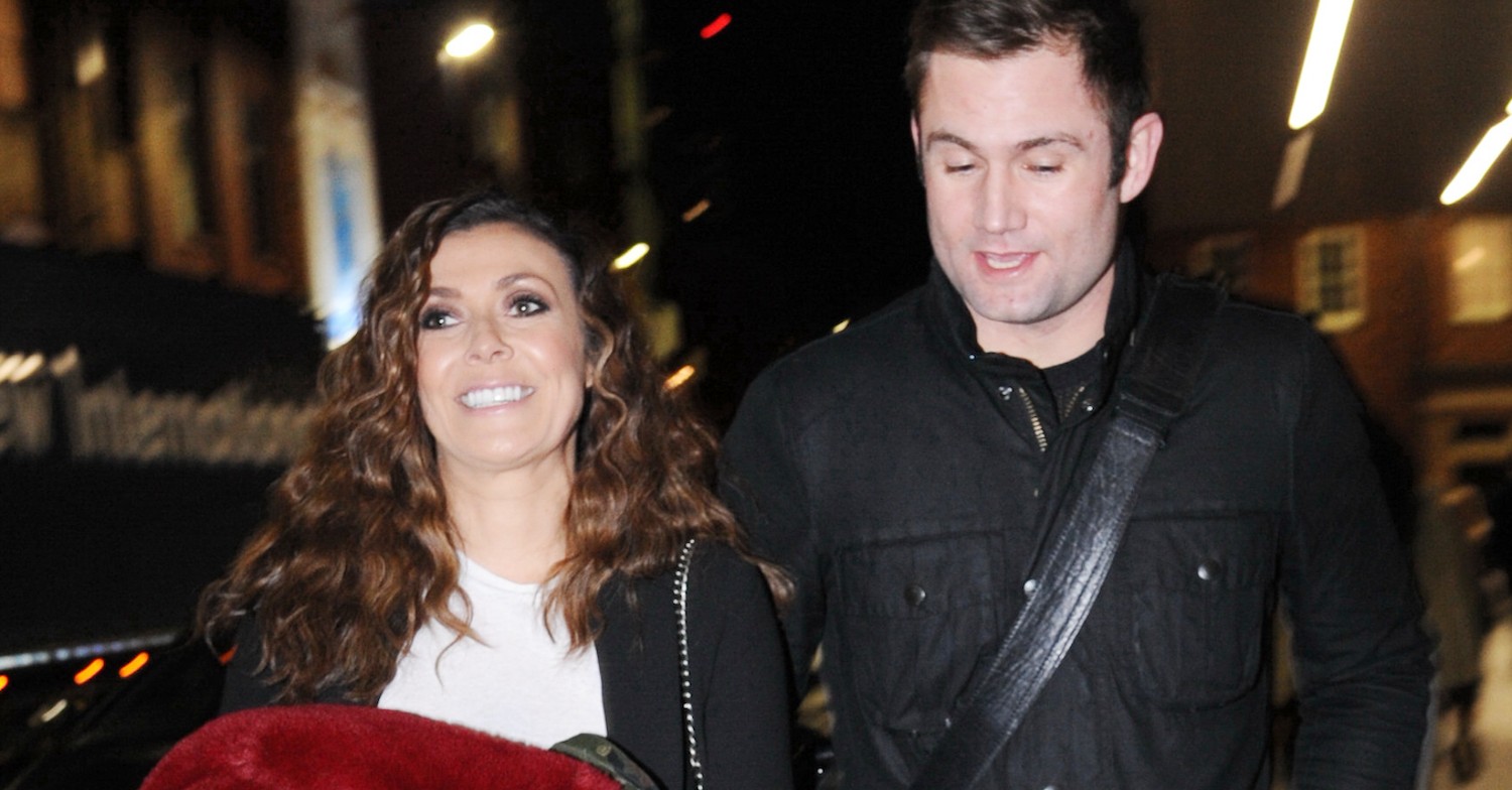 Kym Marsh and her husband on a night out smiling