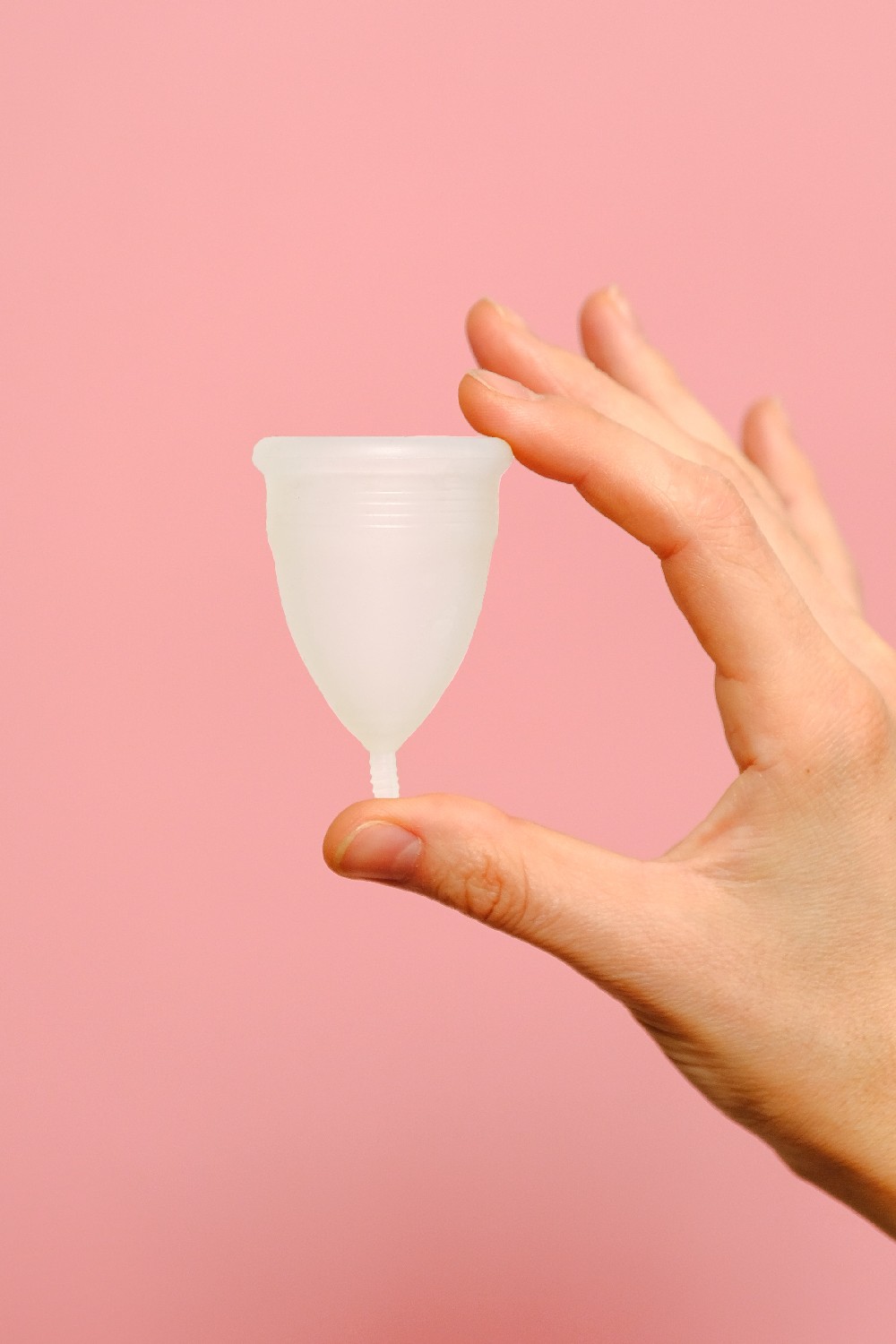 Person holding up a menstrual cup