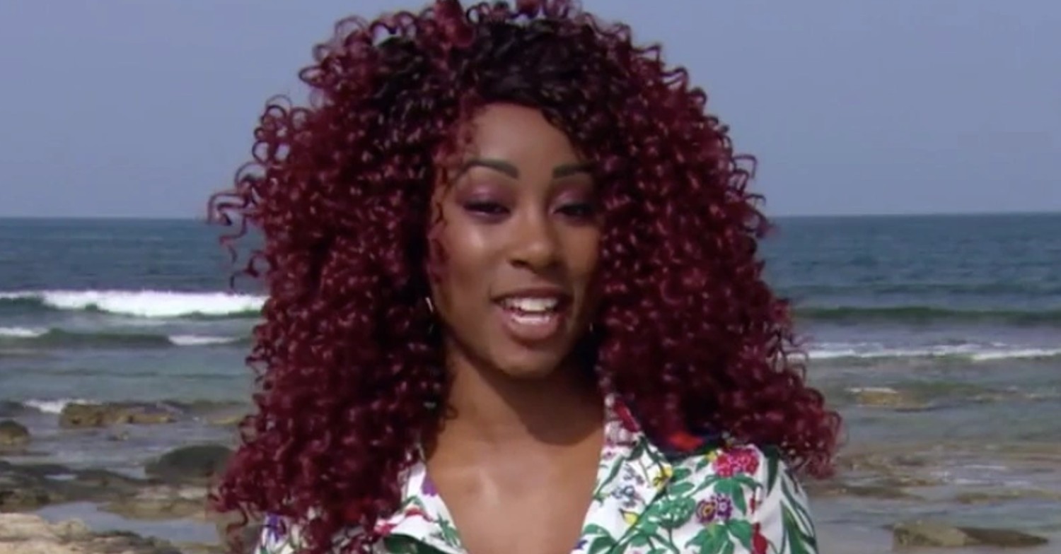 A Place In The Sun presenter Scarlette Douglas smiling on the beach