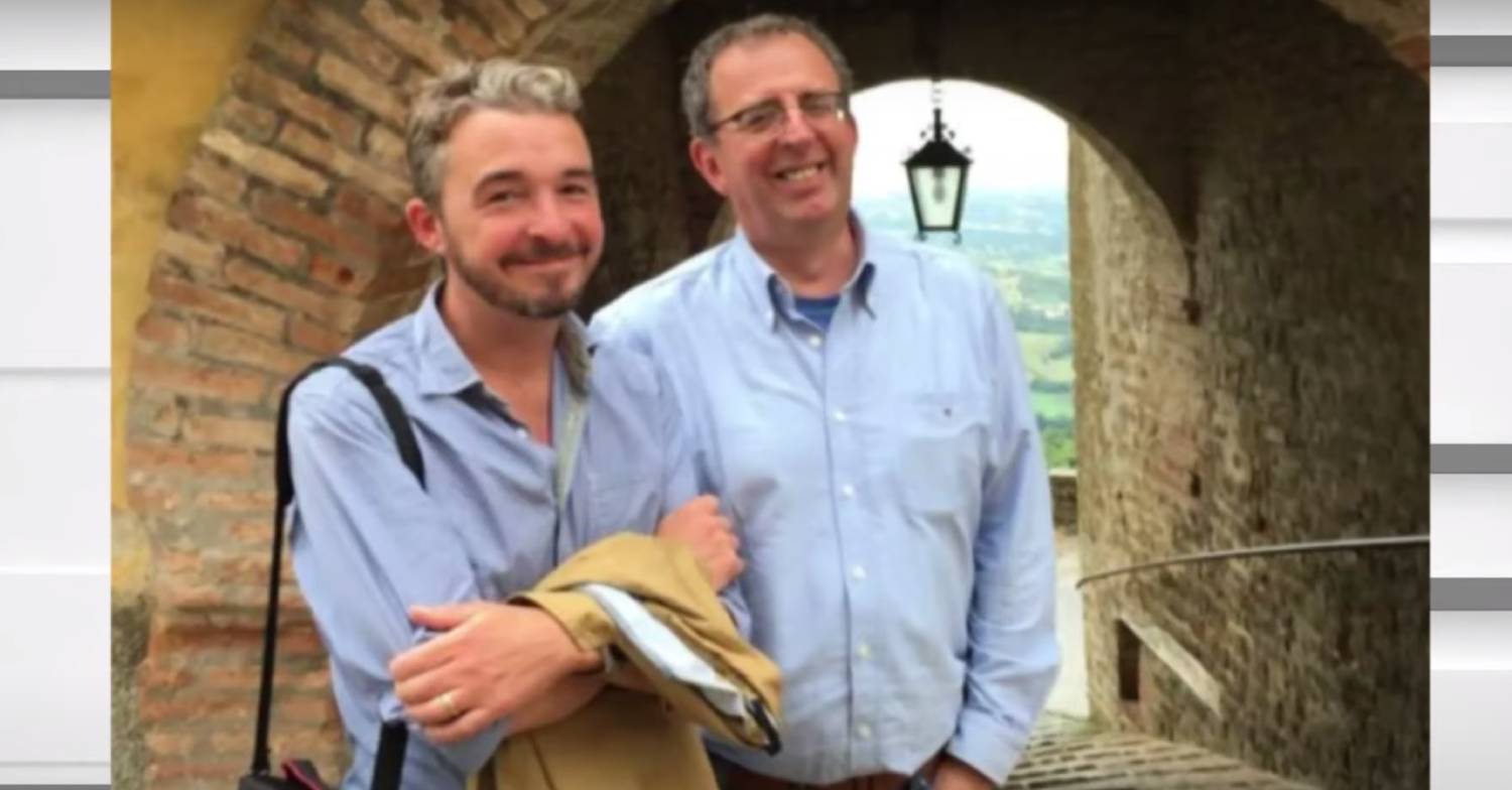 Reverend Richard Coles has his hands in his pockets while his late partner David folds his arms
