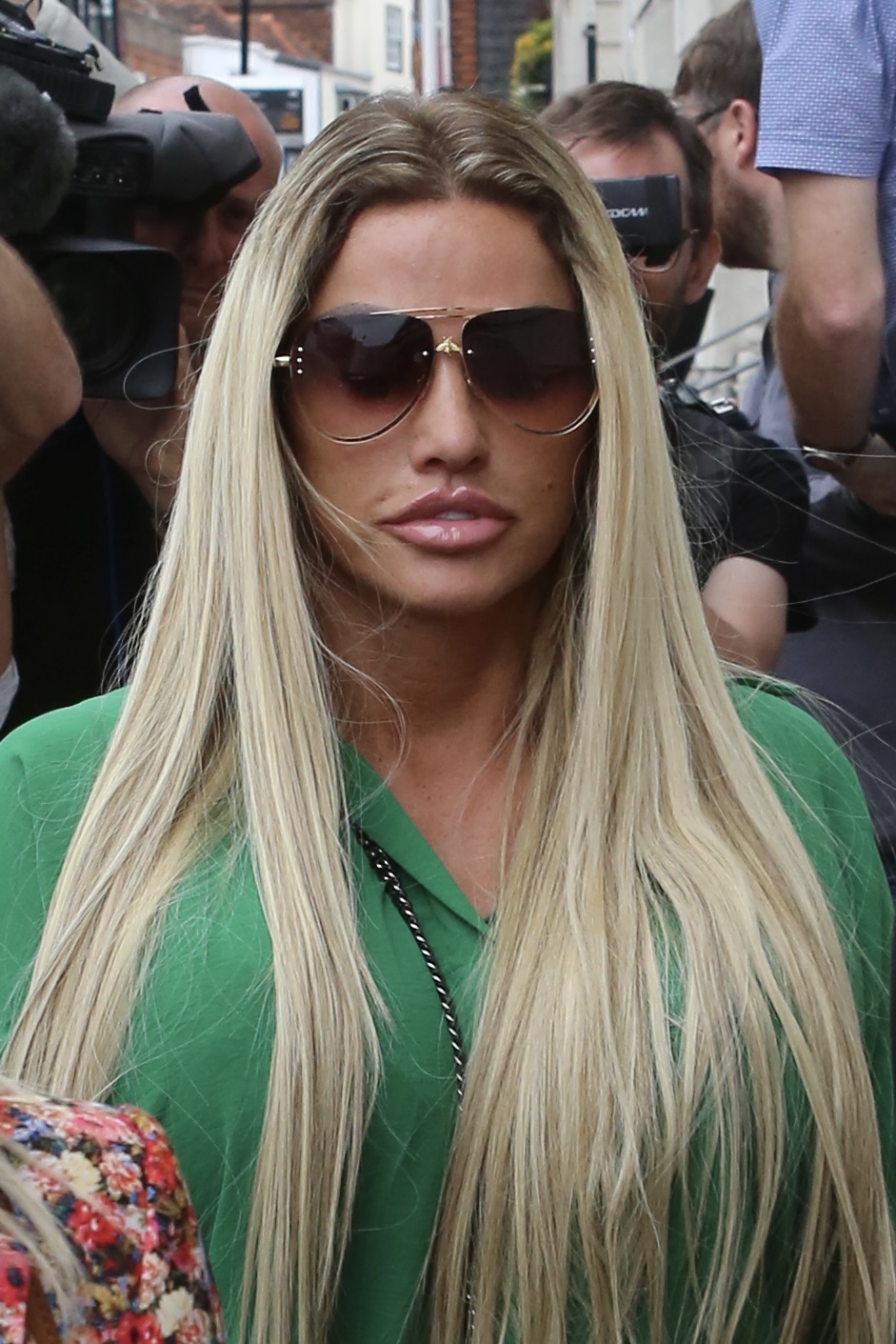 Katie Price wearing green and sunglasses