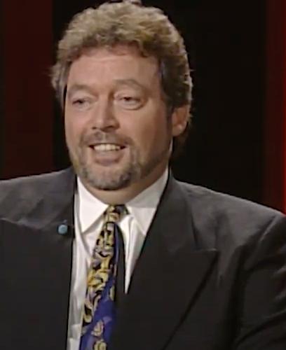 Jeremy Beadle wearing a suit