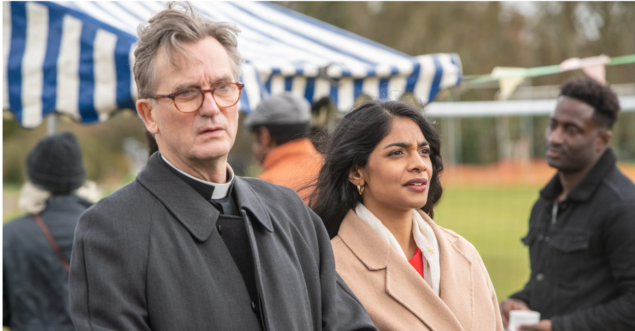Cast of Midsomer Murders at a fete in coats
