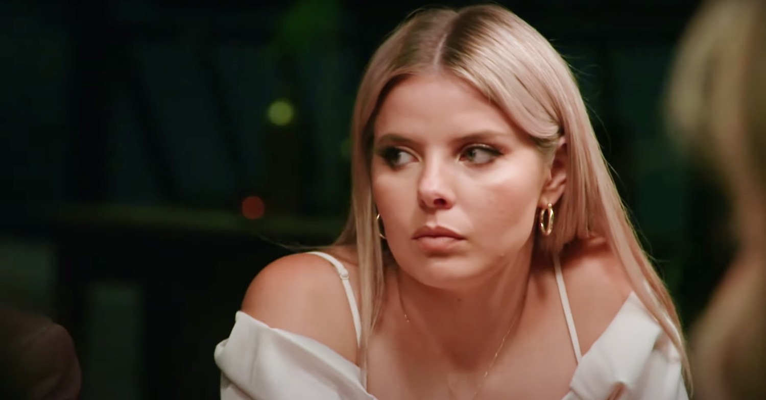 Olivia glaring at the dinner table on Married At First Sight Australia