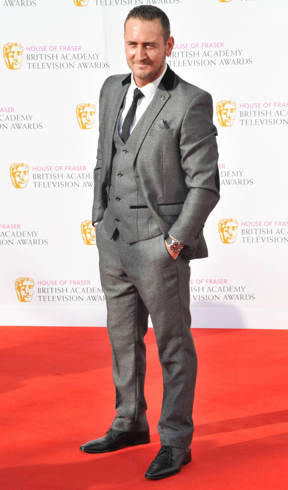Posing on the red carpet in a suit