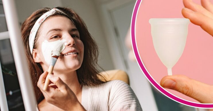Woman putting on face mask in the mirror and a menstural cup