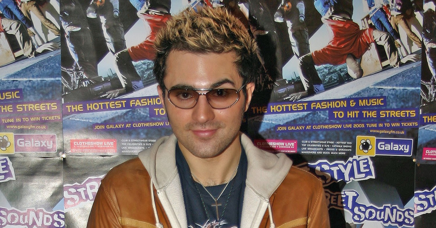 Pop Idol star Darius Campbell Danesh with bleached tips and sunglasses, smiling 