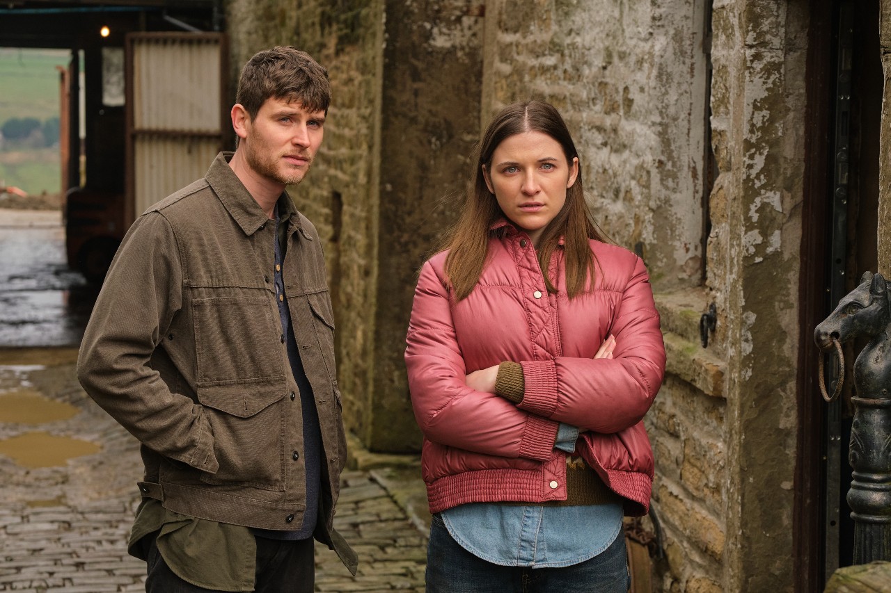 :CONOR LOWSON as Steve Parry and ALEXANDER HANNANT as Catherine.