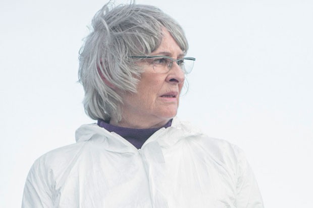 Shetland, Anne Kidd as Cora, she is in her forensics suit, looking right with a stressed expression