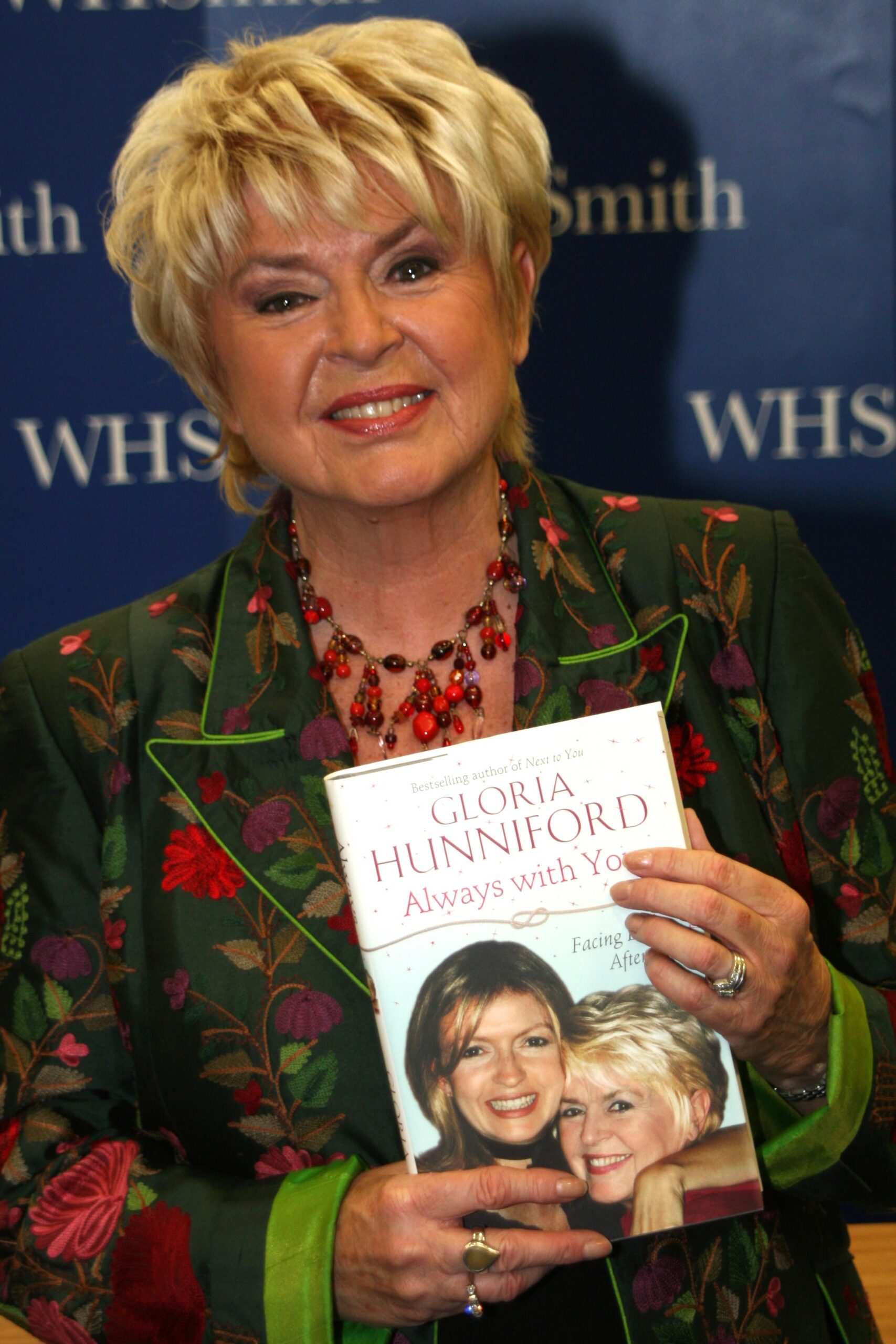 Gloria Hunniford posing with her book about her daughter Caron