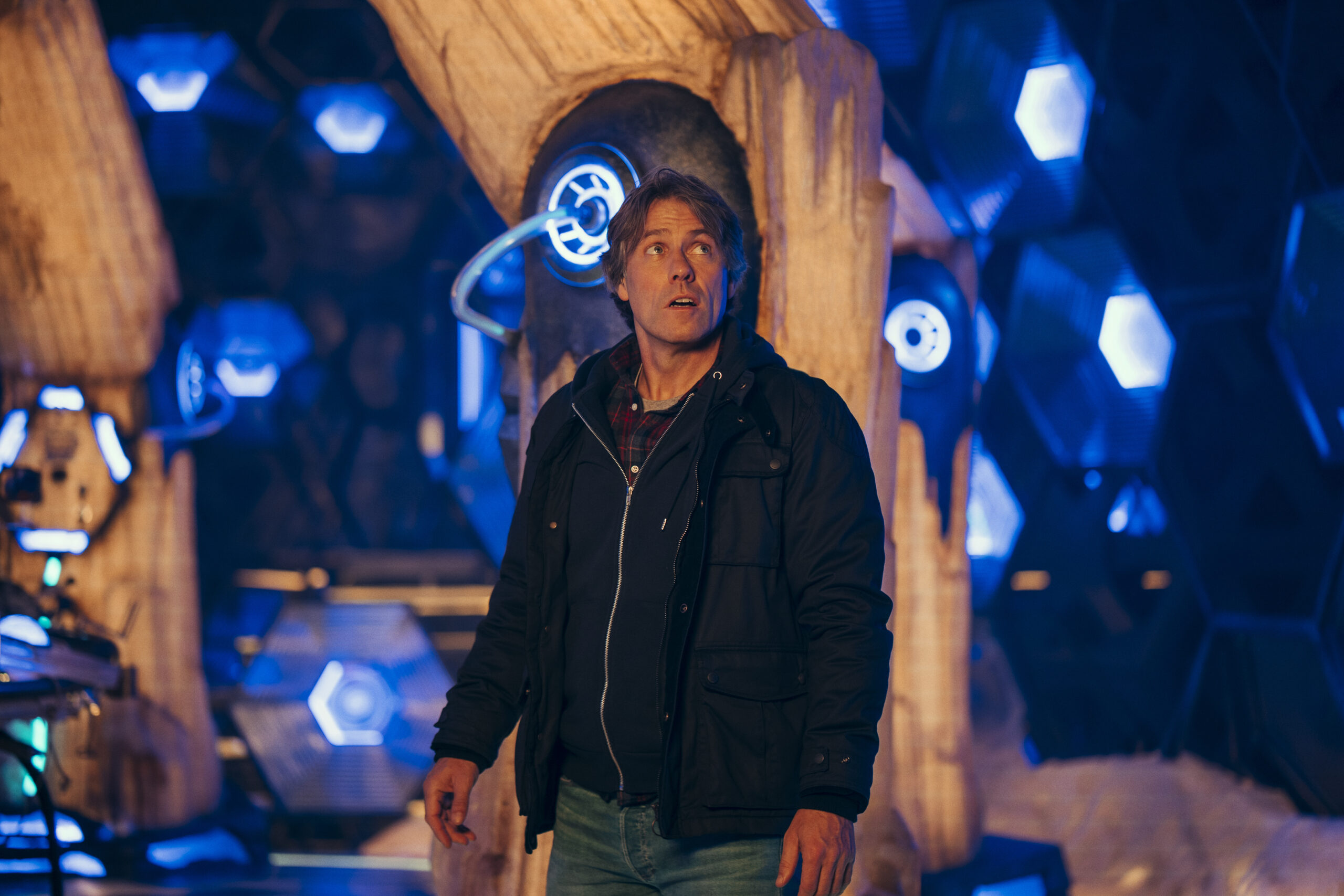 John Bishop as Dan in Doctor Who, he looks up in a black jacket in the tardis