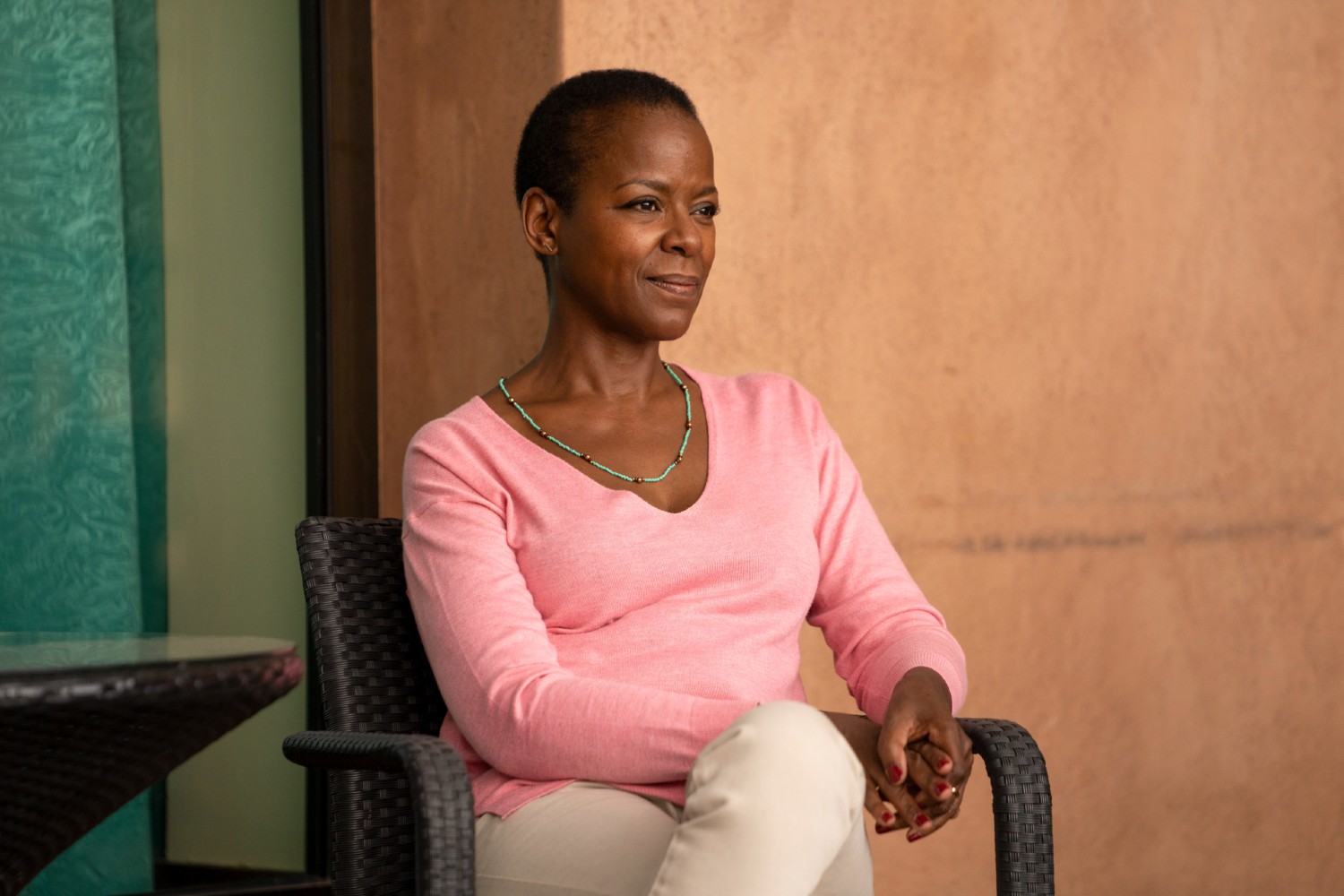 Josette Simon wearing a pink top and smiling slightly
