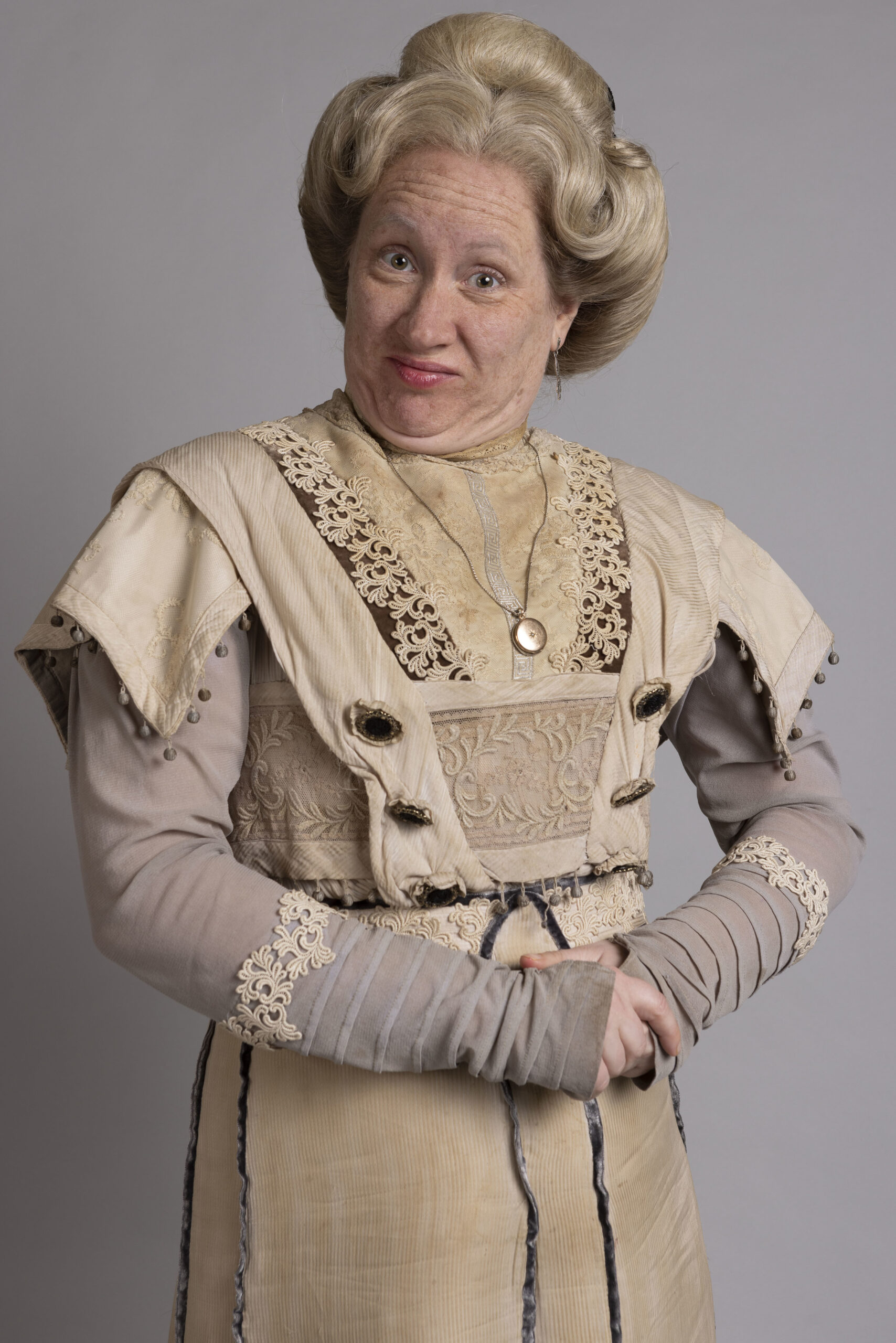 Martha Howe Douglas as Lady Button, she looks into the camera with a dis-approving face in Victorian dress