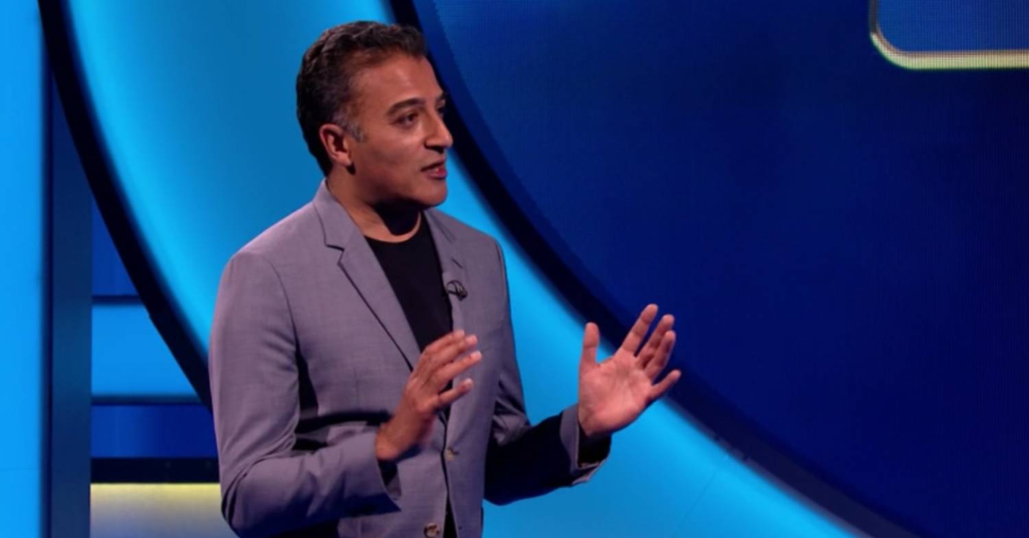 Adil Ray holds his hands up as he hosts a game of Lingo on ITV