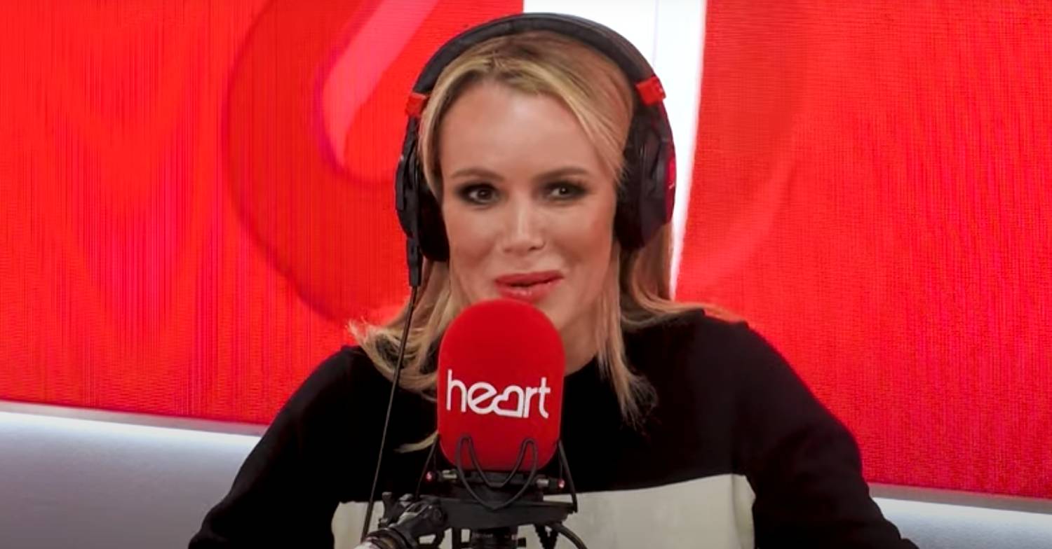 Amanda Holden speaks into a microphone