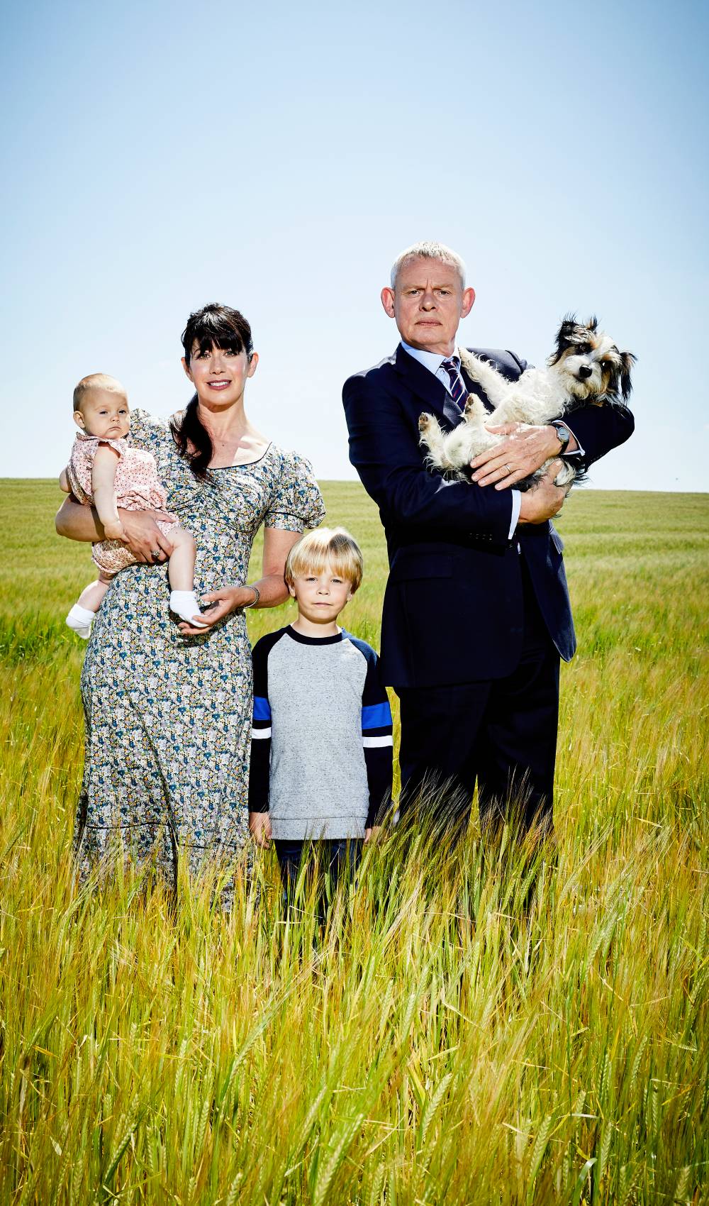 Doc Martin stars Martin Clunes and Caroline Catz stand in a field in new series 10