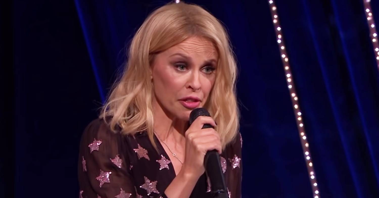 Kylie Minogue speaks into the microphone