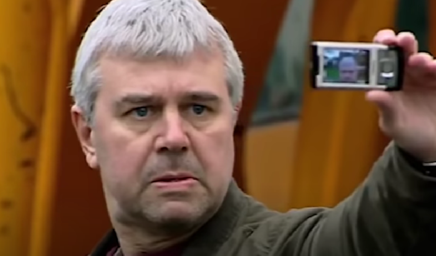 Ralph holding up a phone in Waterloo Road 
