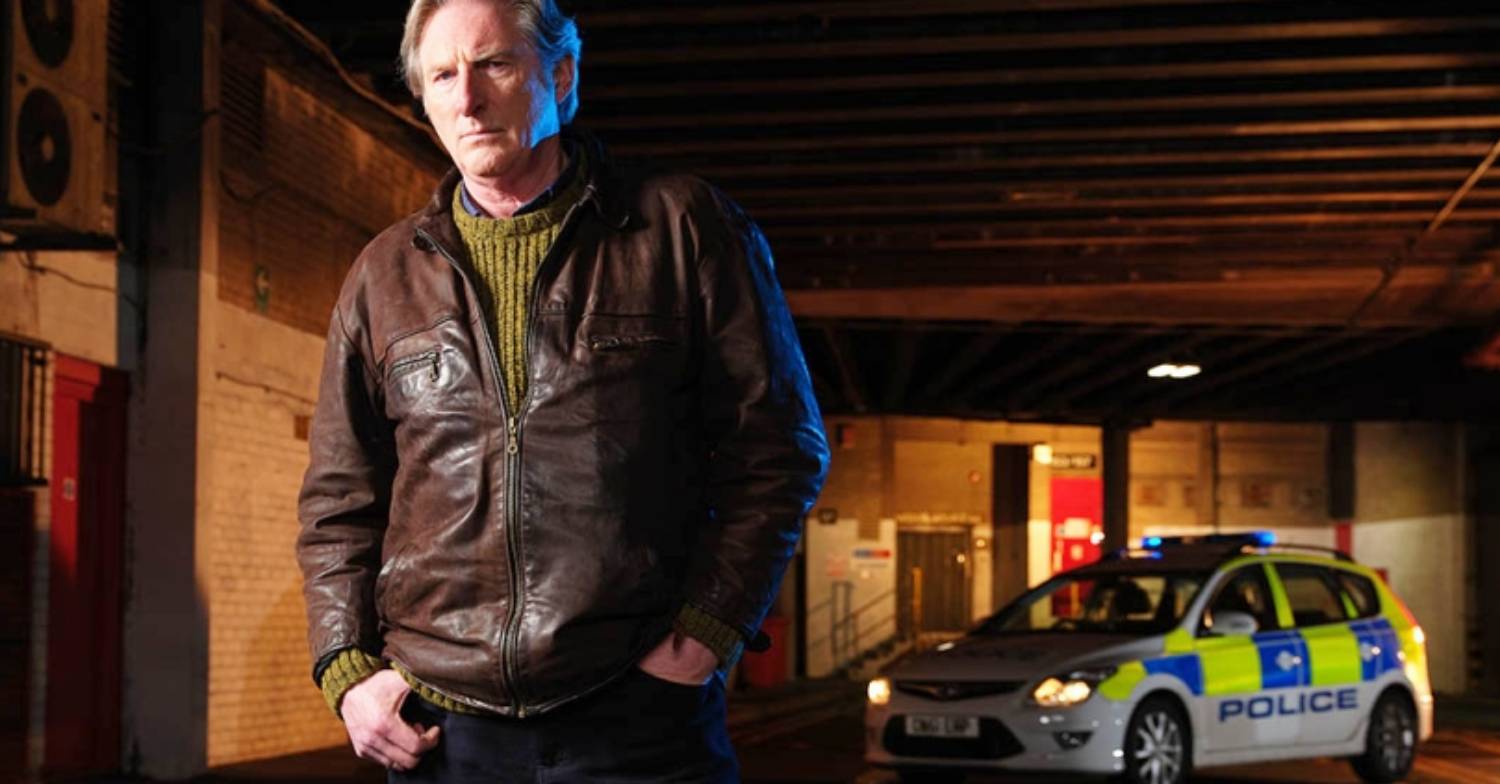 Adrian Dunbar frowns in character as Alex Ridley