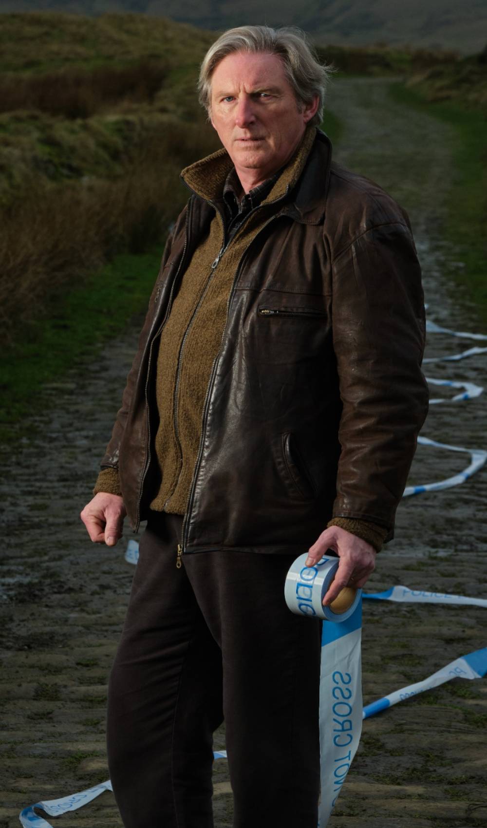Adrian Dunbar hold tape as Alex Ridley