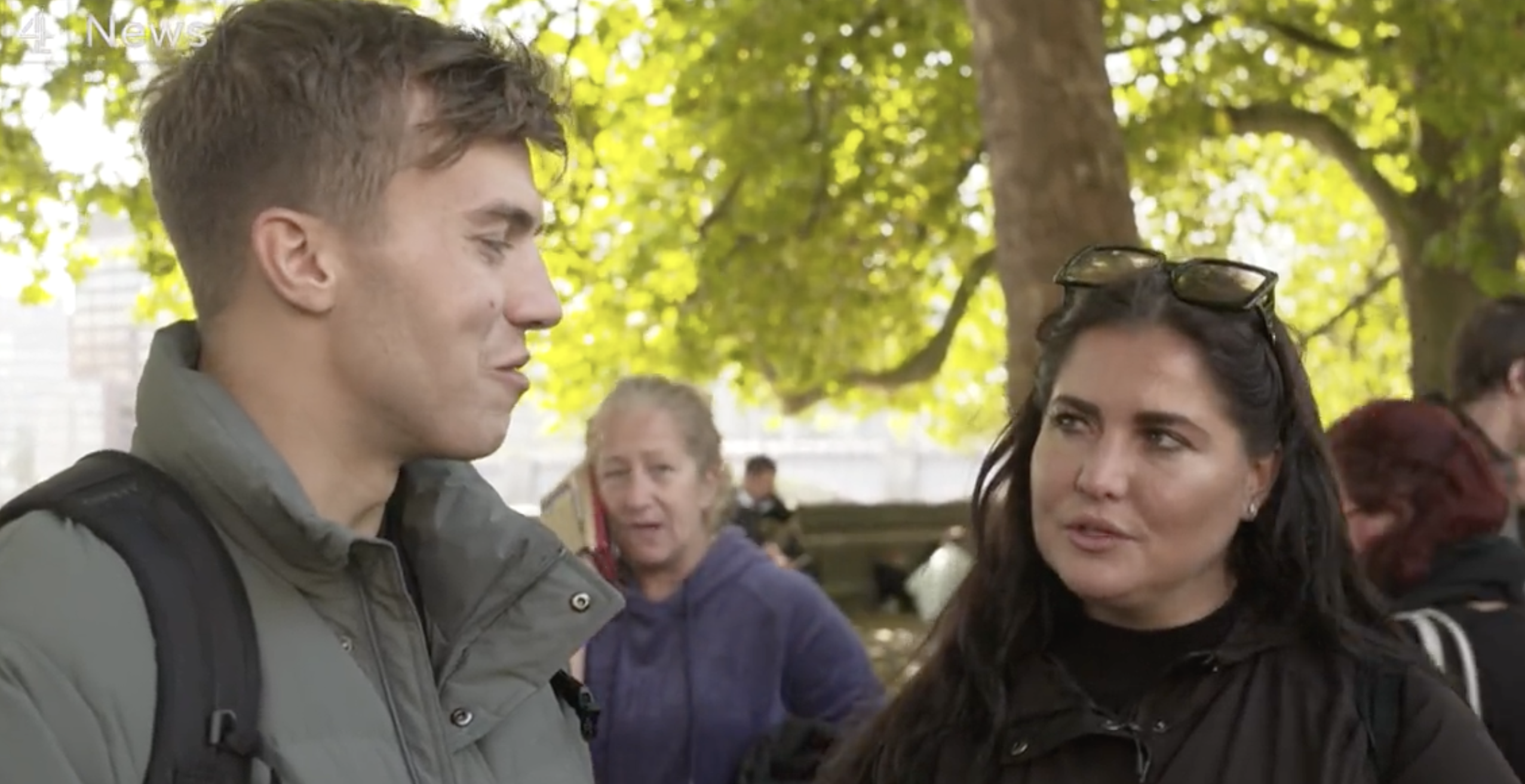 Jack and Zoe looking at each other in the queue
