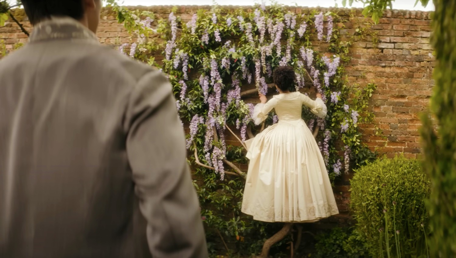 India Amarteifio scaling the garden walls in Queen Charlotte: A Bridgerton Story
