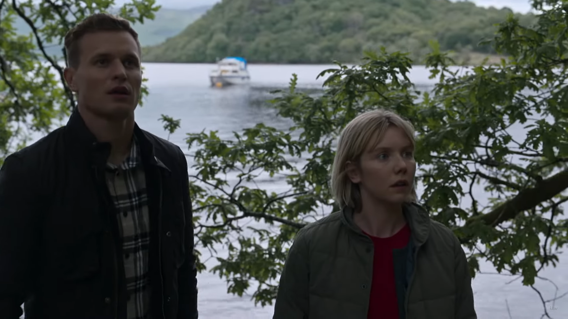 Laura Lyle and Chris Jenks star in Karen Pirie, the background is water and greenery