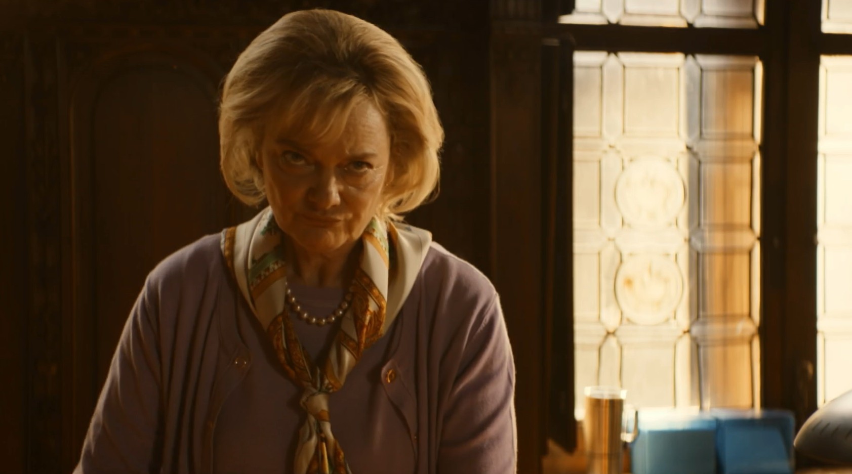 Sarah Woodward as Ms Ingrid Snares, she looks up angrily at Professor T, in his home