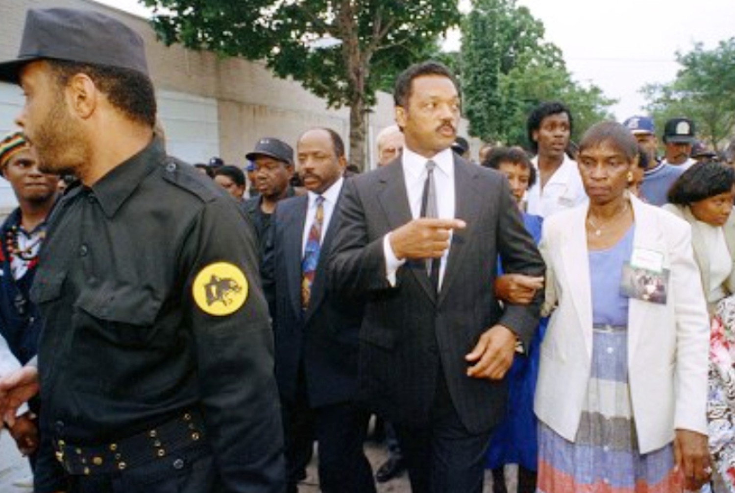 Shirley Hughes being escorted by Rev. Jesse Jackson