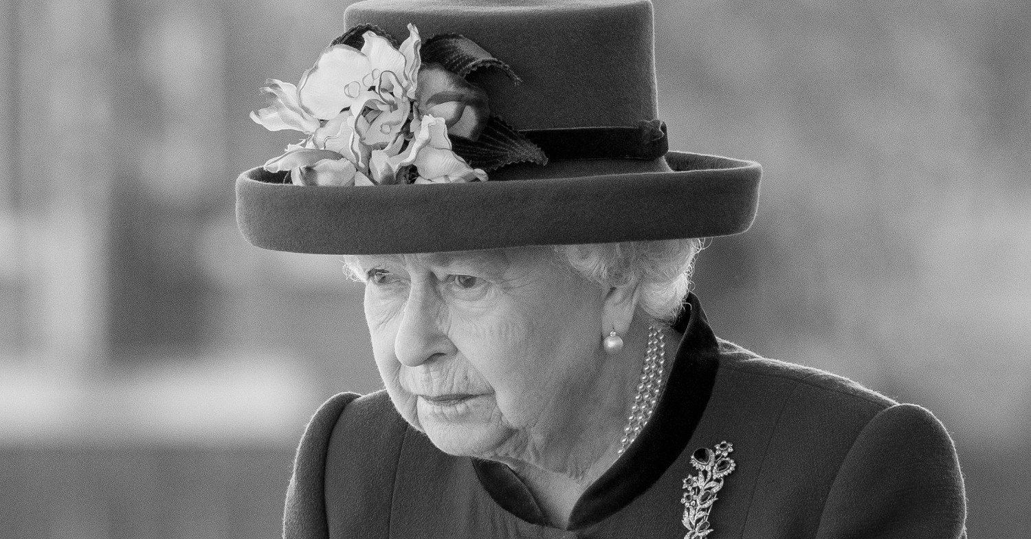The Queen looking downcast in black and white