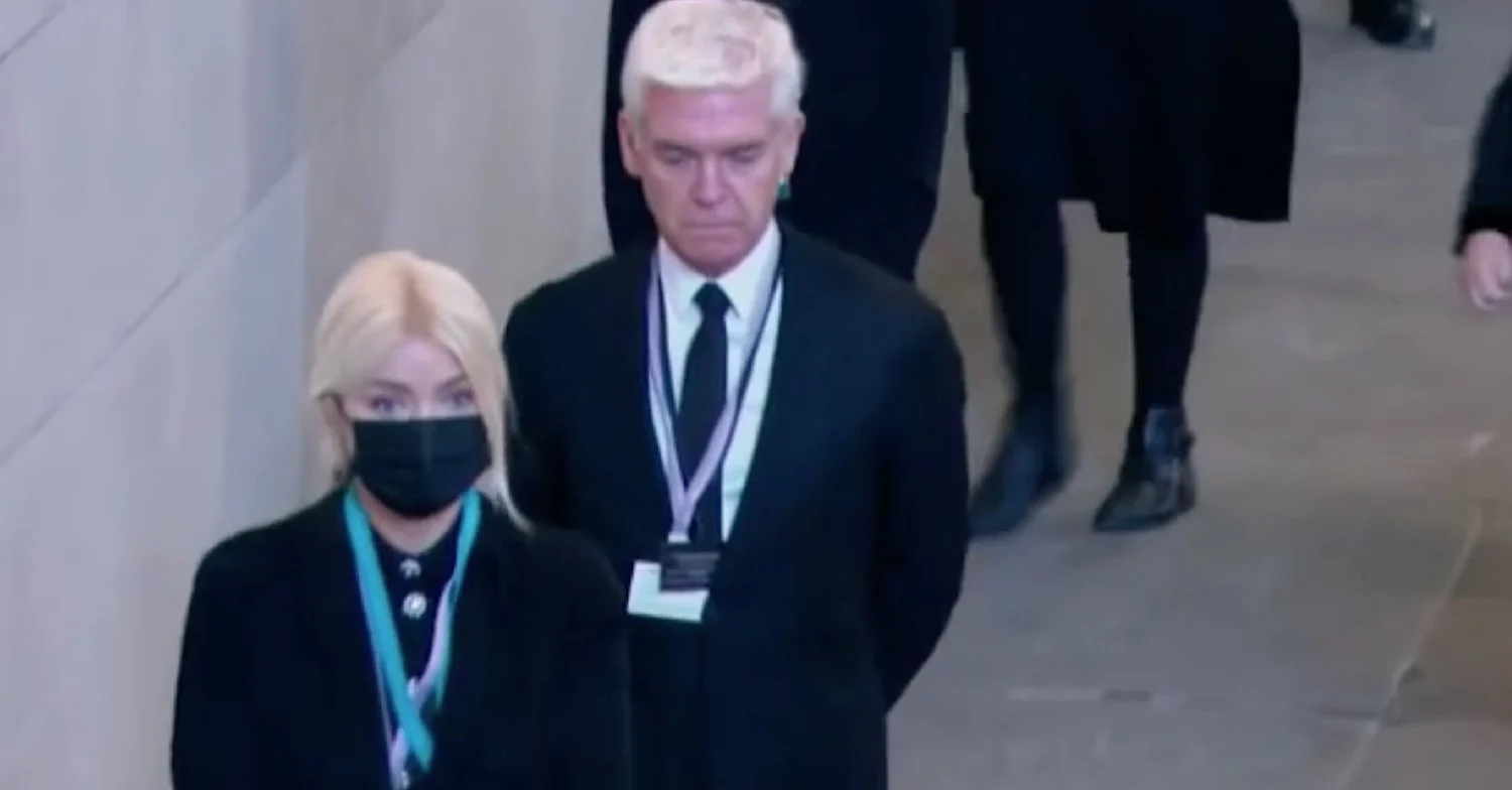 ITV This Morning stars Holly WIlloughby (wearing a mask) and Phillip Schofield in the queue to see the Queen lying-in-state