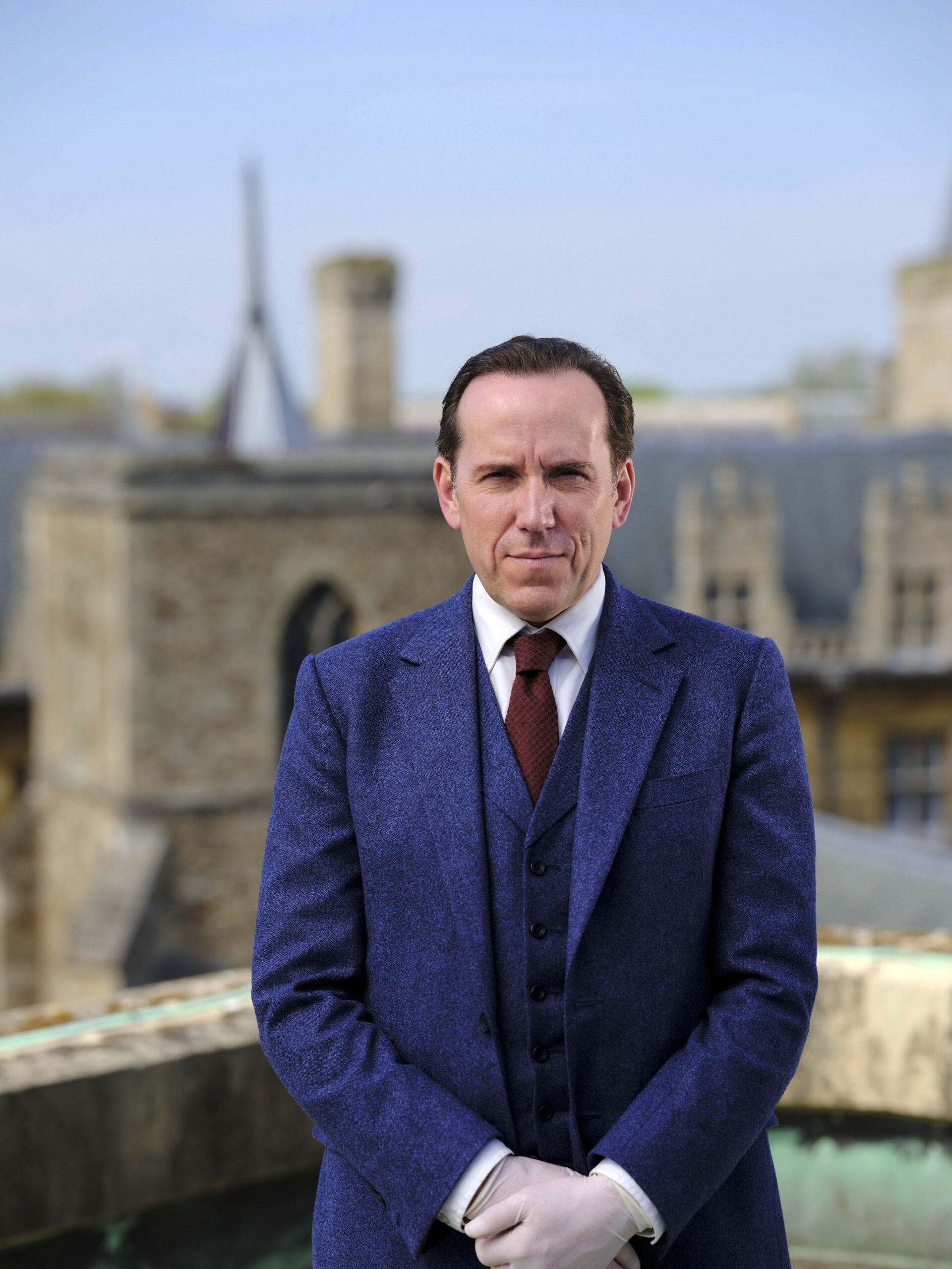 Ben Miller as Professor Jasper Tempest, he smiles at the camera on his roof with a suit and gloves on