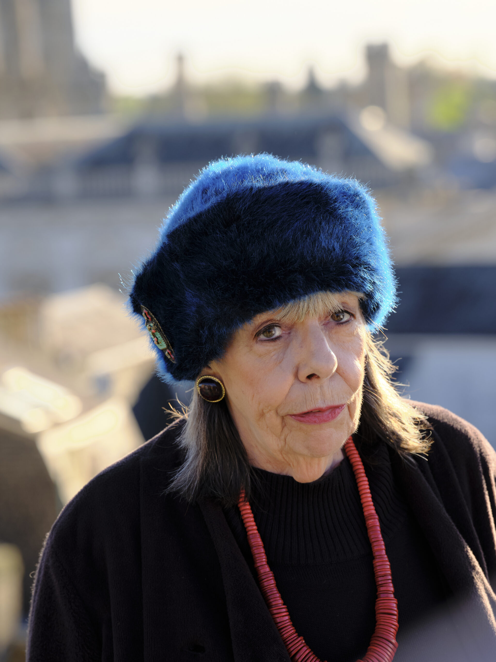 Frances de la Tour as Adelaide in Professor T series two cast, she stands on Jaspers roof with a blue fur hat and black fur coat on