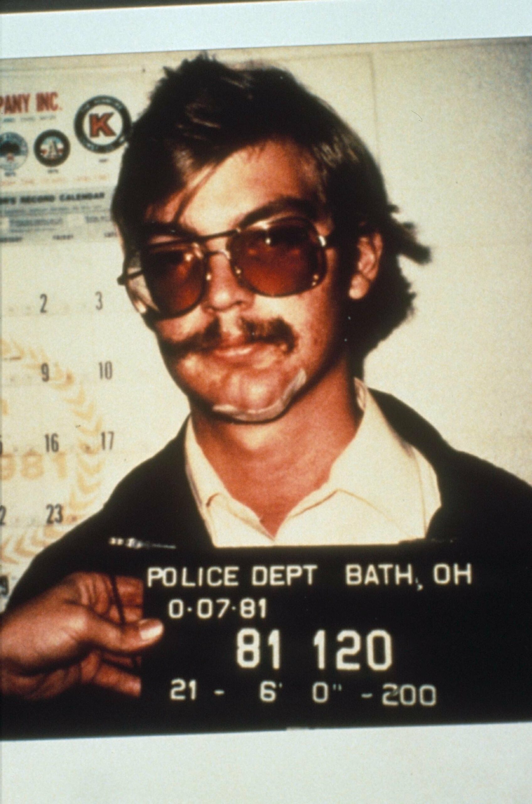 Jeffrey Dahmer mugshot wearing dark glasses