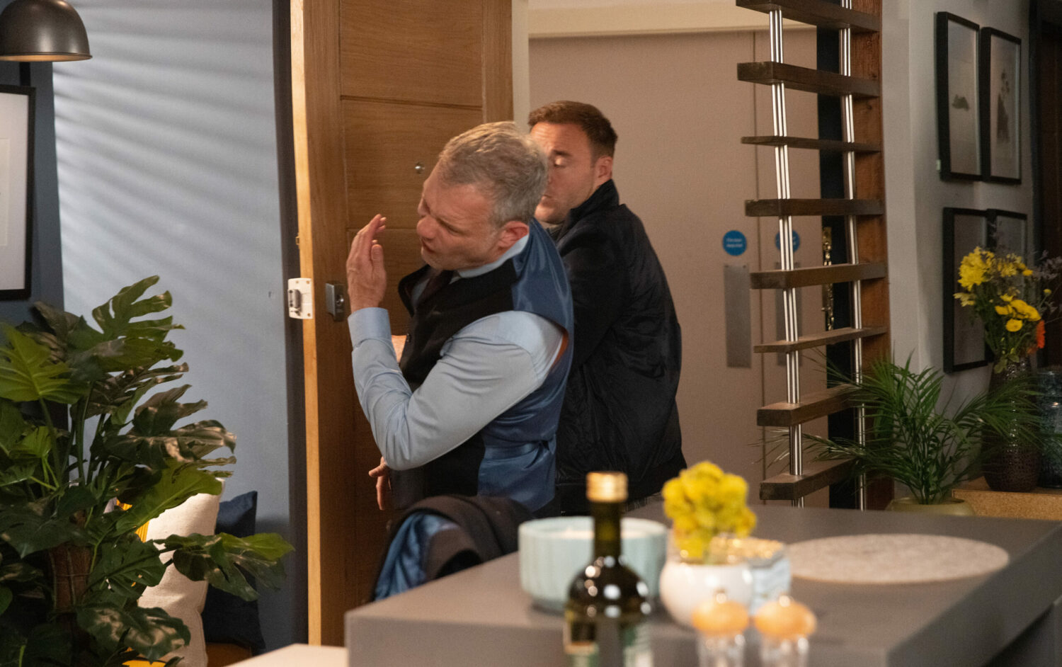 Tyrone punches Nick at the door of his flat in Coronation Street