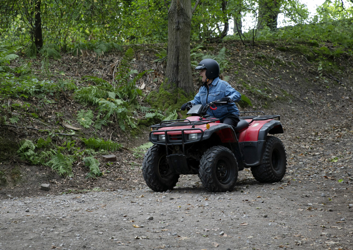 Harriet on a quad bike in the woods Emmerdale 
