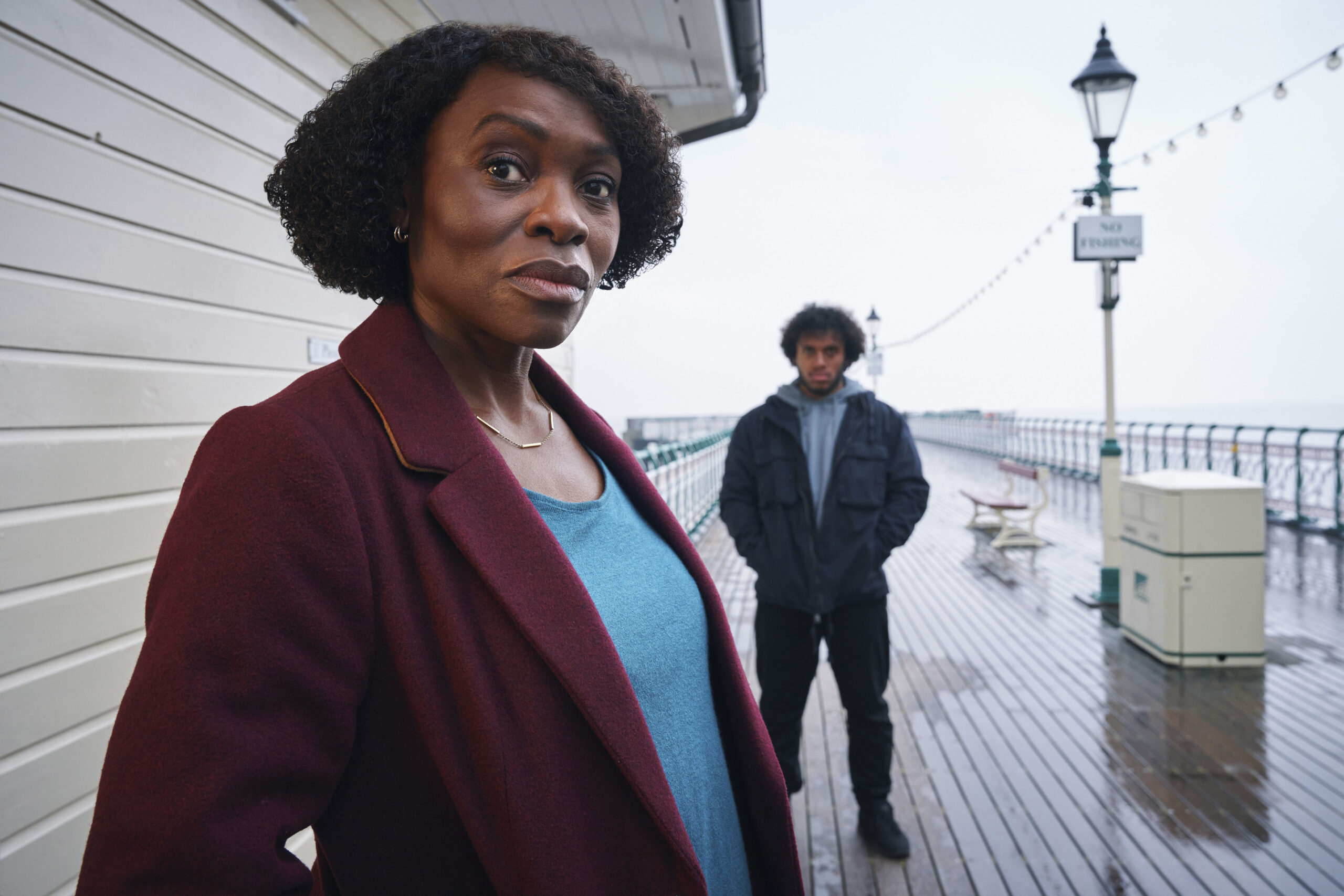 Rakie Ayola as Christine in The Pact series 2 with Connor standing behind her on a pier