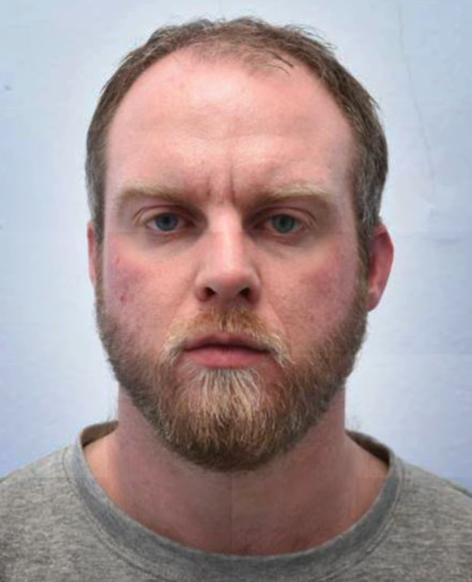Chris Lythgoe's mug shot, he wears a grey top and has a slight frown