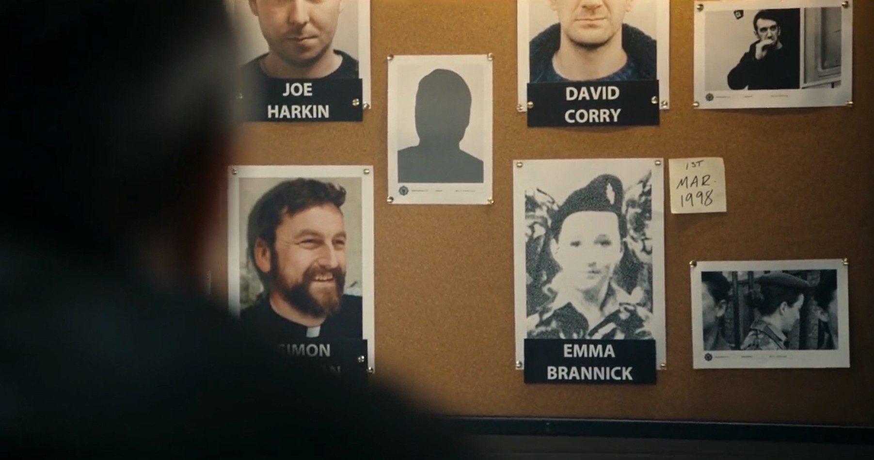 Black and white image of Emma Brannick in Bloodlands, the image is on a police board amongst other images from the Goliath case