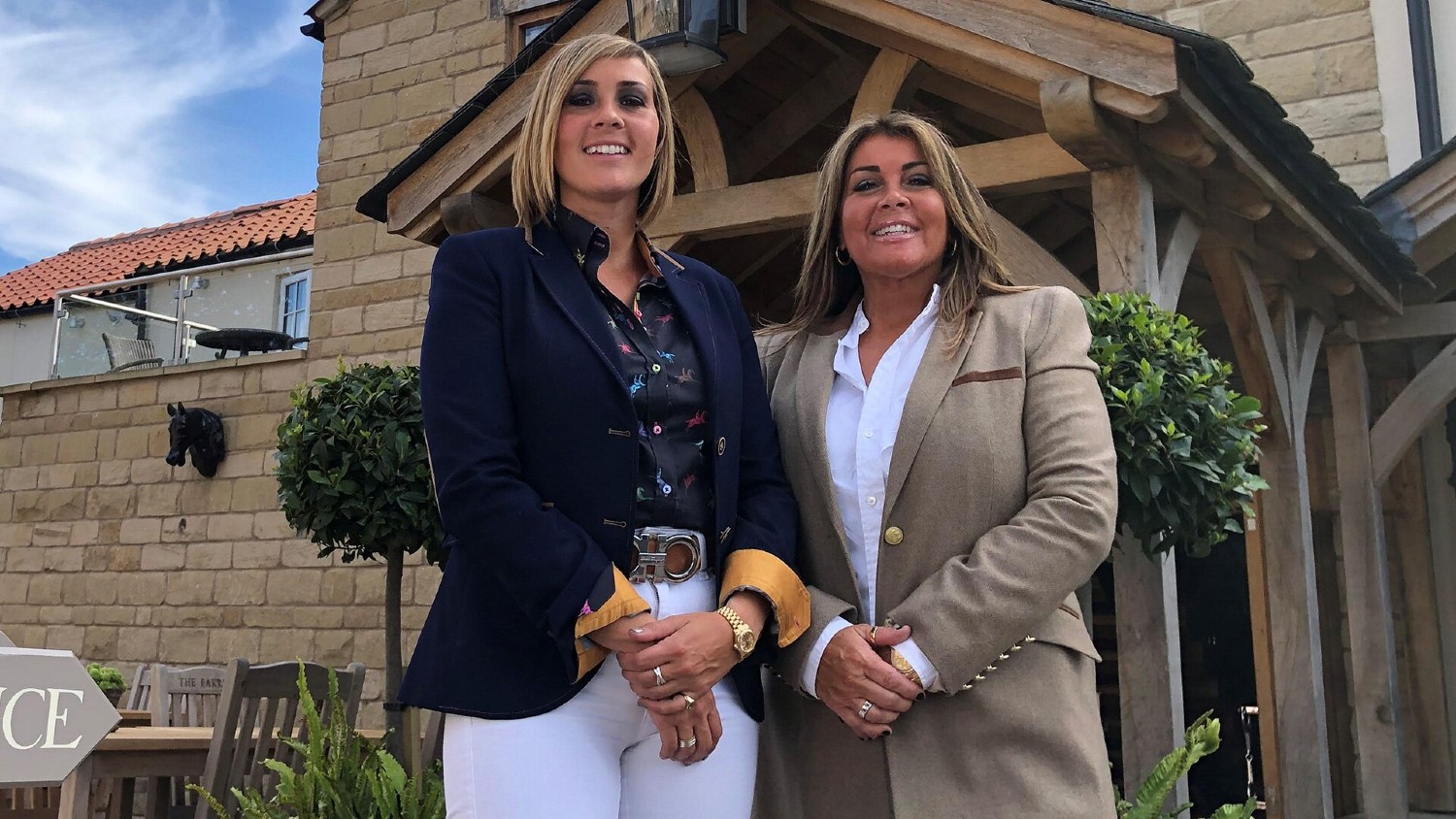 Suzie and Dani standing outside their hotel in Four in a Bed