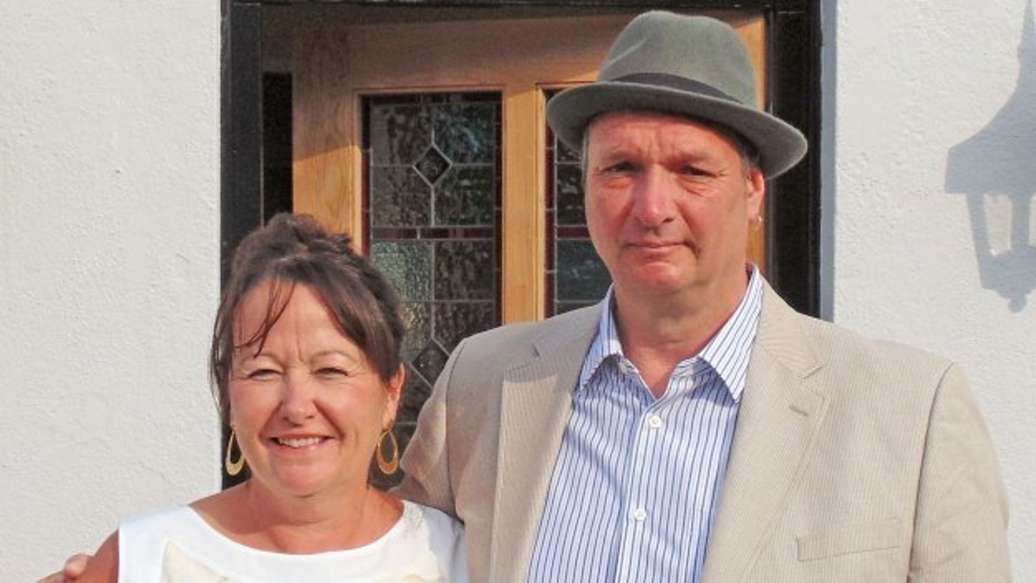Kevin and Julie standing in front of their hotel in Four in a Bed