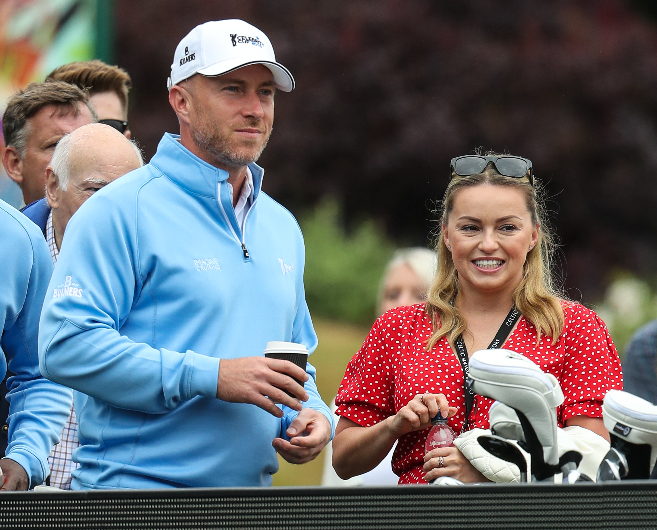 Strictly stars James and Ola Jordan smiling at golf game