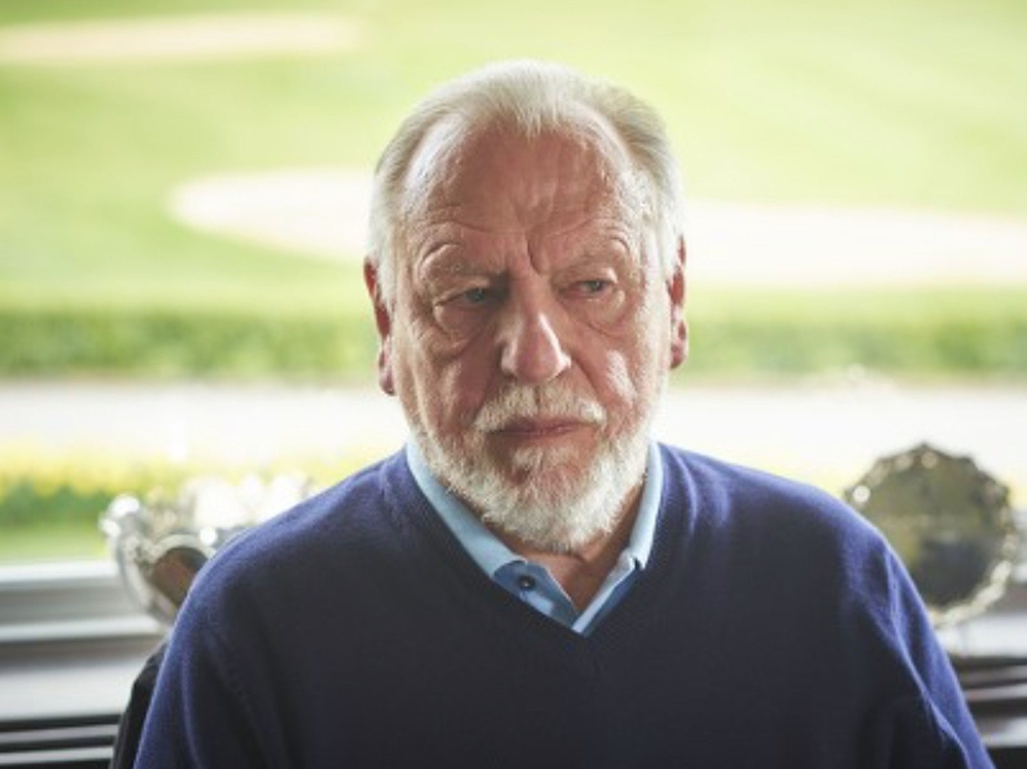 Kenneth Cranham looking to the side with a straight face