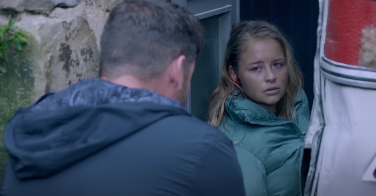 Liv looking sad at Aaron as she's crushed by the caravan 