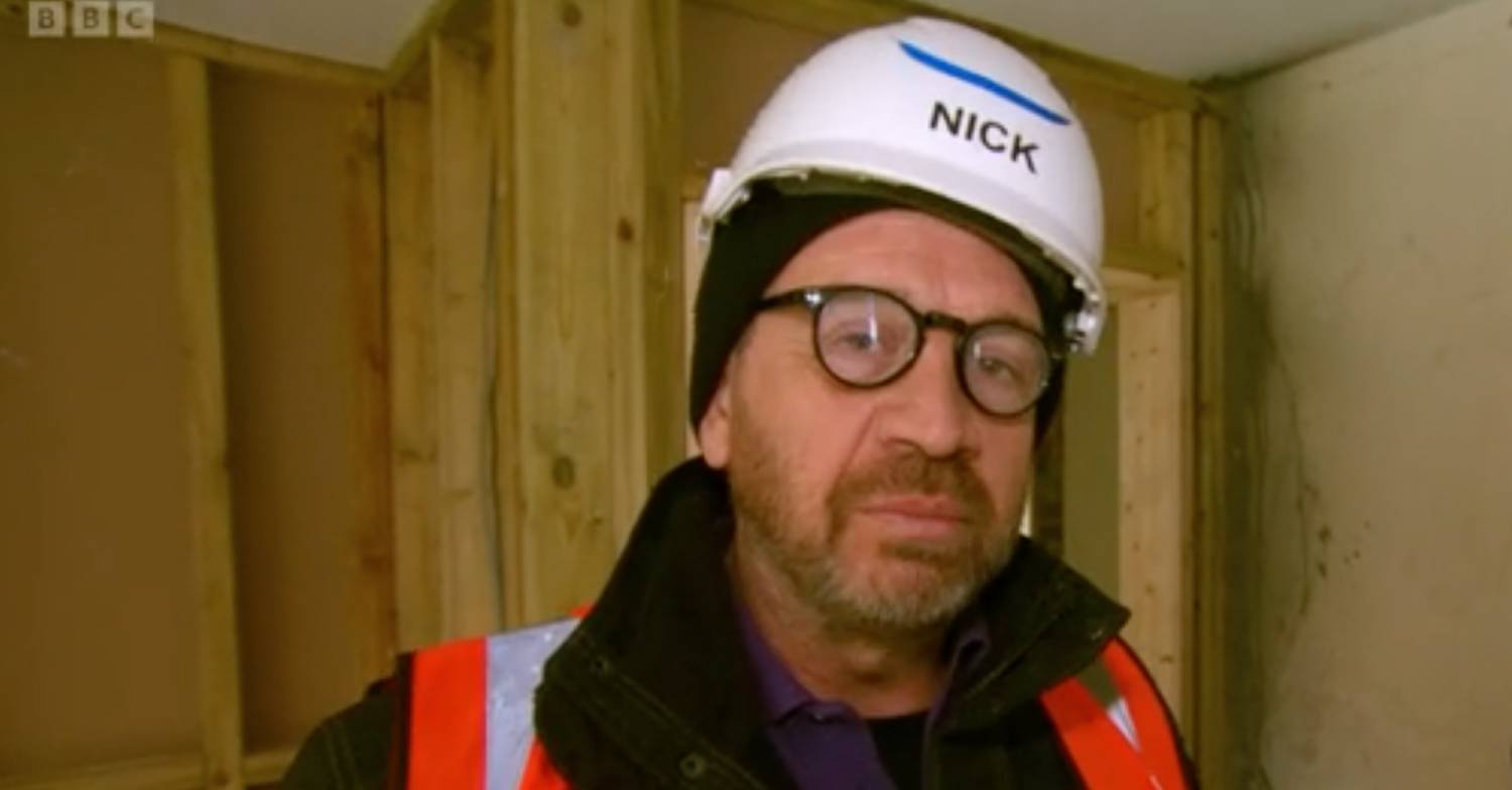 Nick Knowles wears a helmet during an episode of DIY SOS