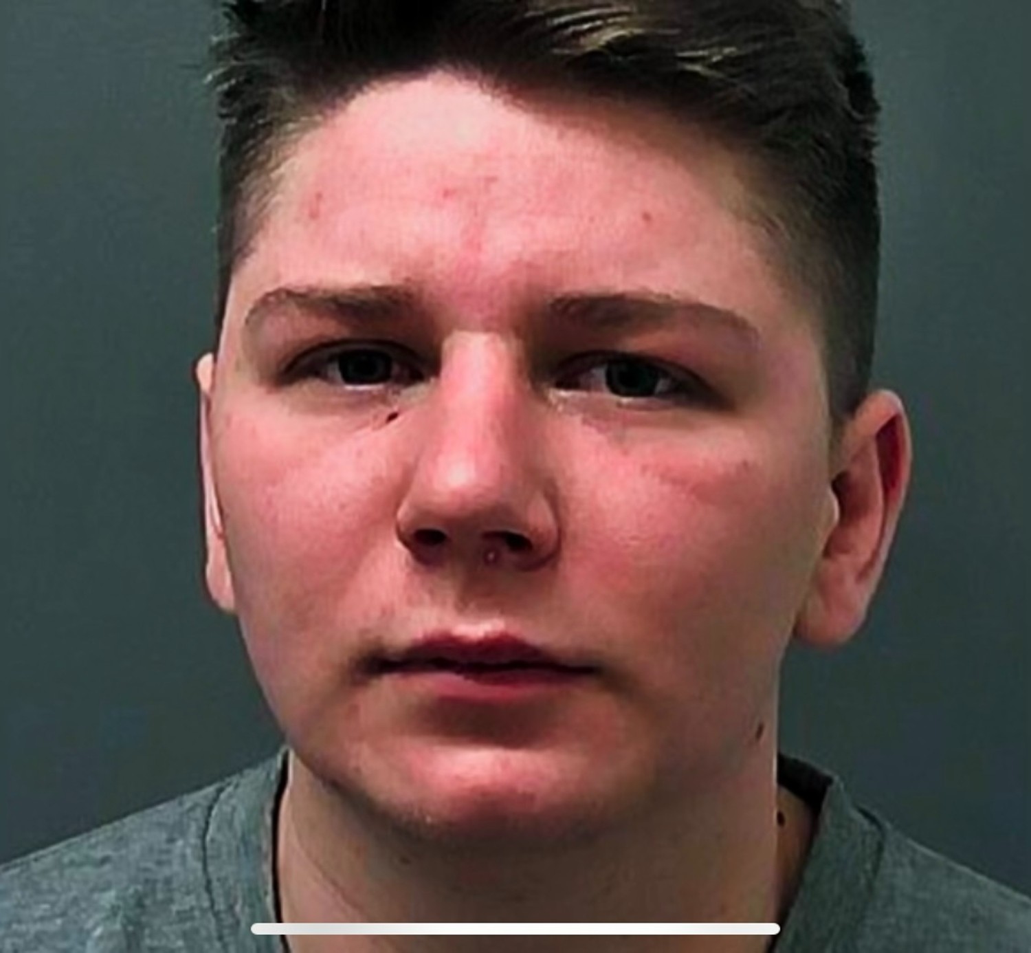 Pawel Relowicz looking serious in prison mugshot