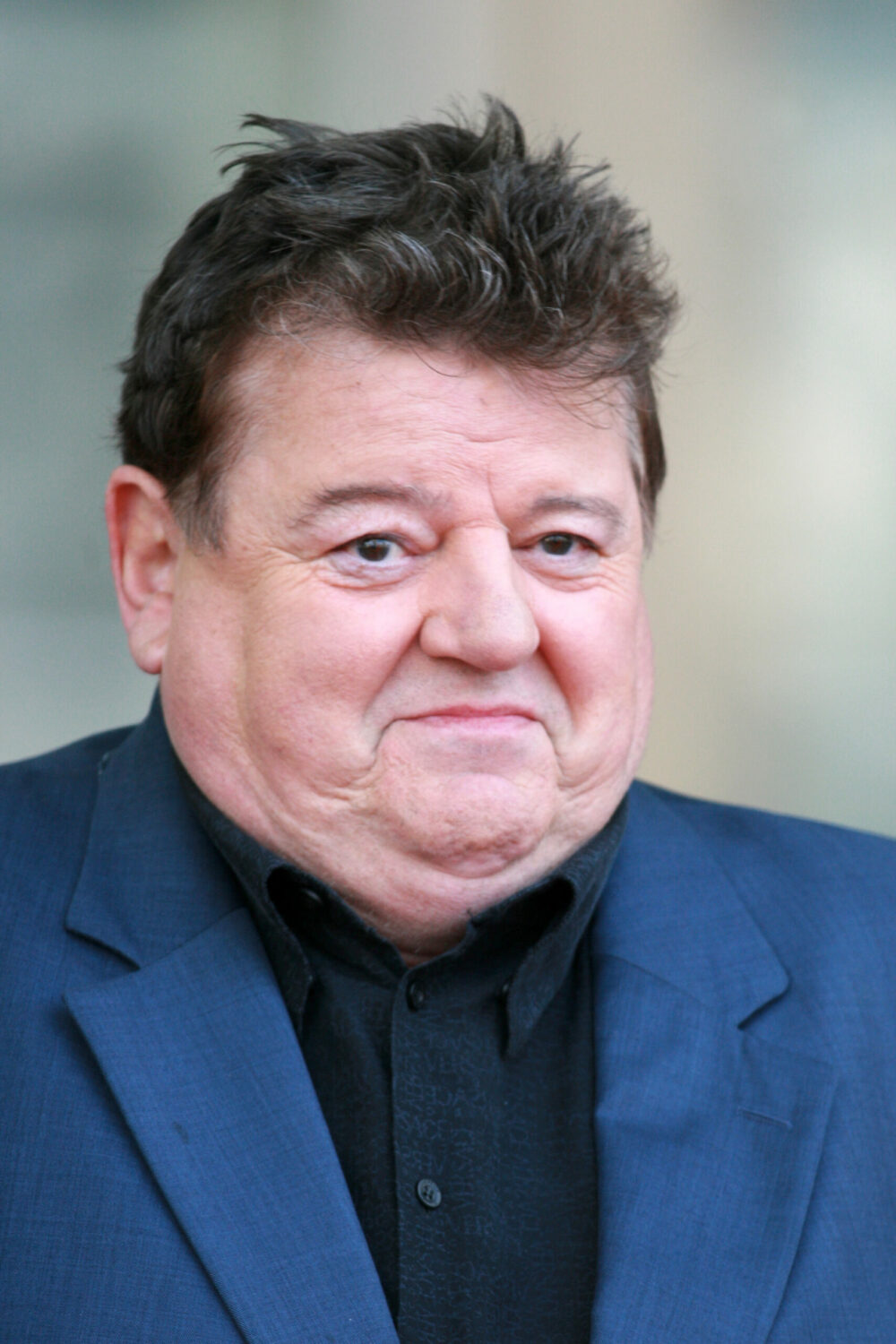 Robbie coltrane smiles on red carpet