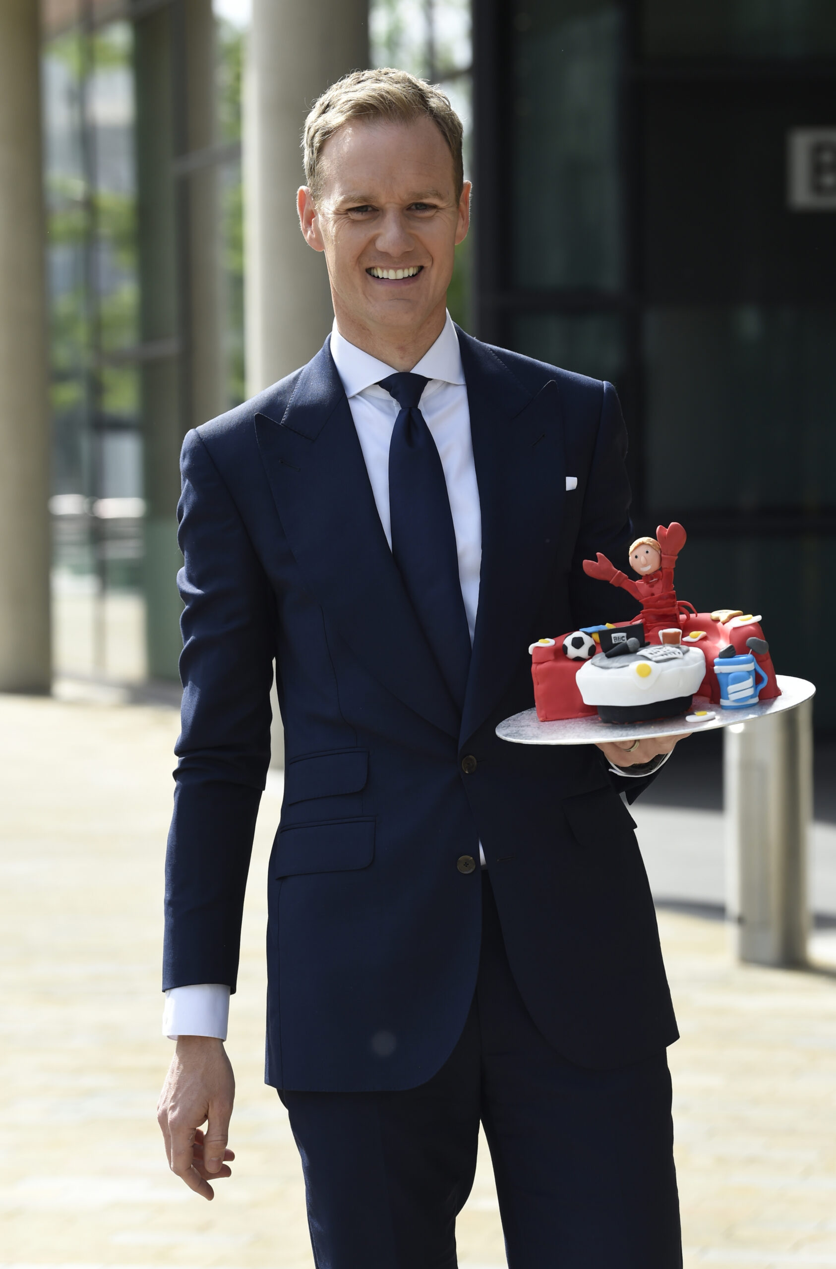 Dan Walker smiling outside BBC studios in Media City