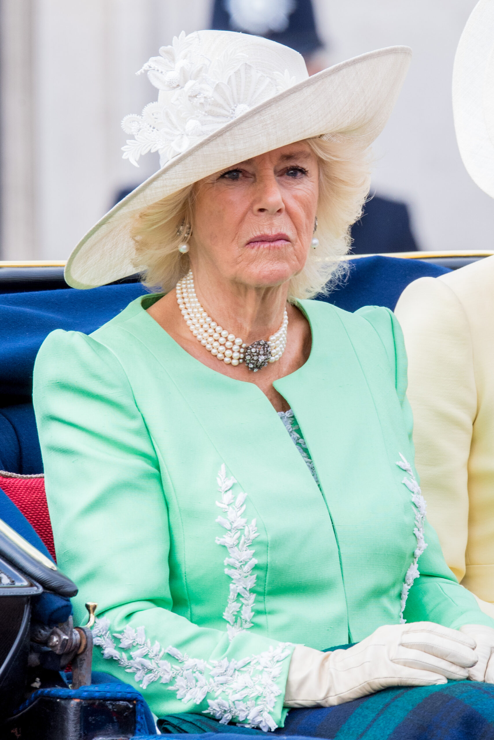 Camilla looking glooming in a green jacket and hat